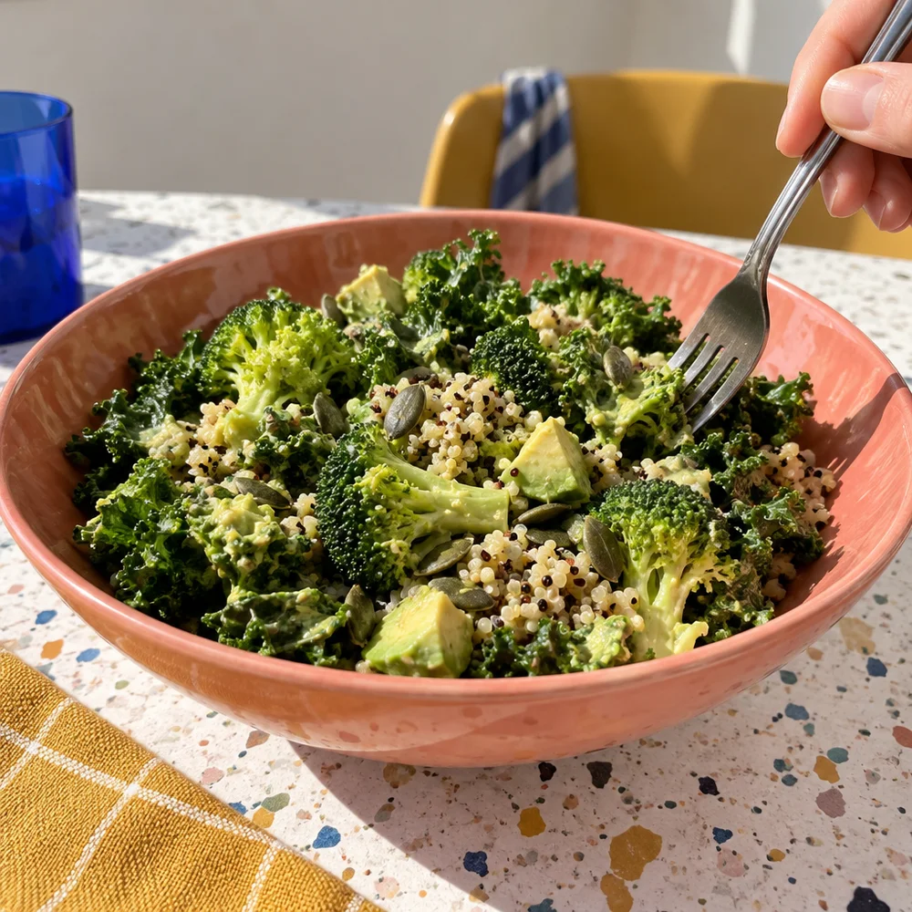 Vegan kale and broccoli bowl with quinoa and avocado dressing