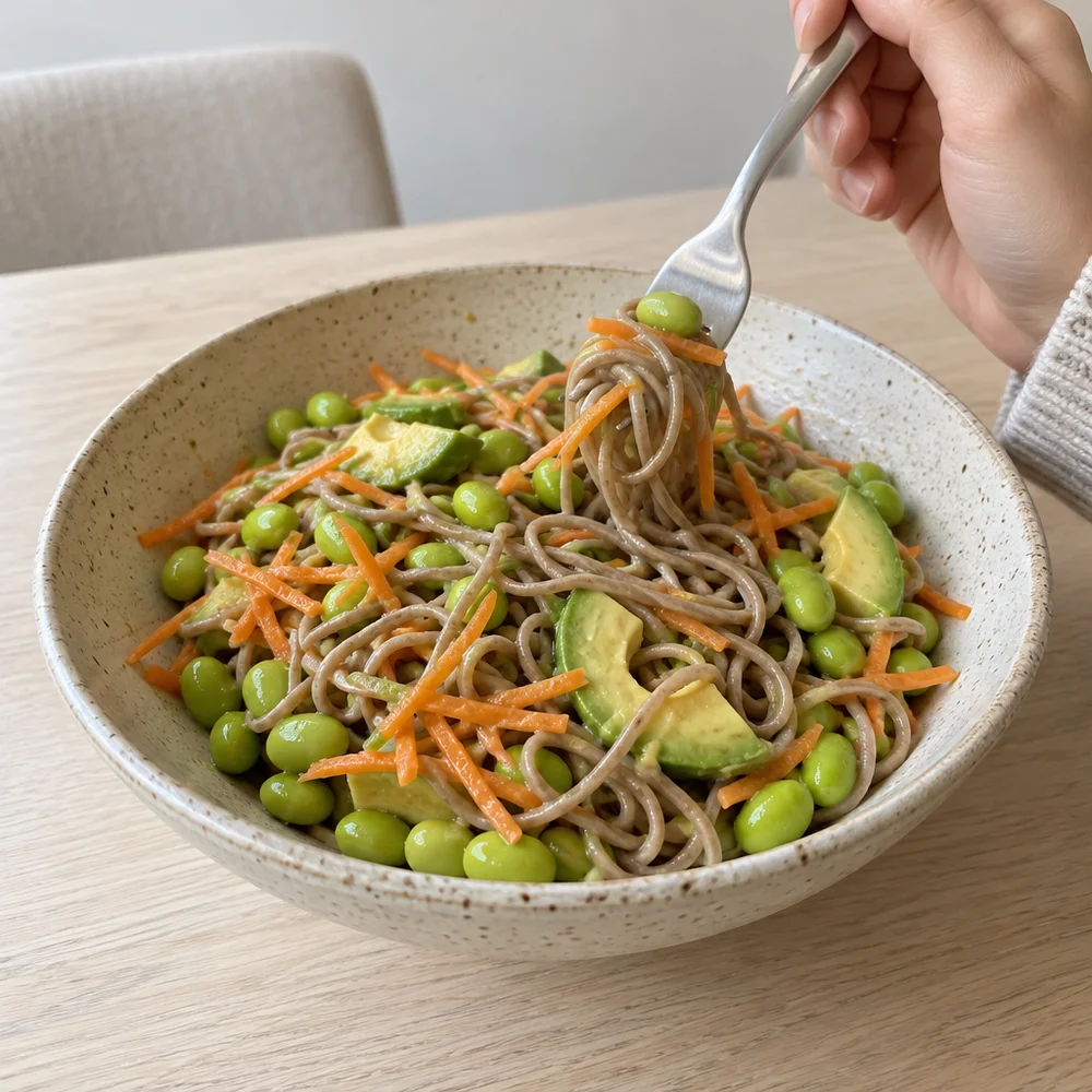 Vegan Japanese soba noodle bowl with edamame and ginger sesame dressing