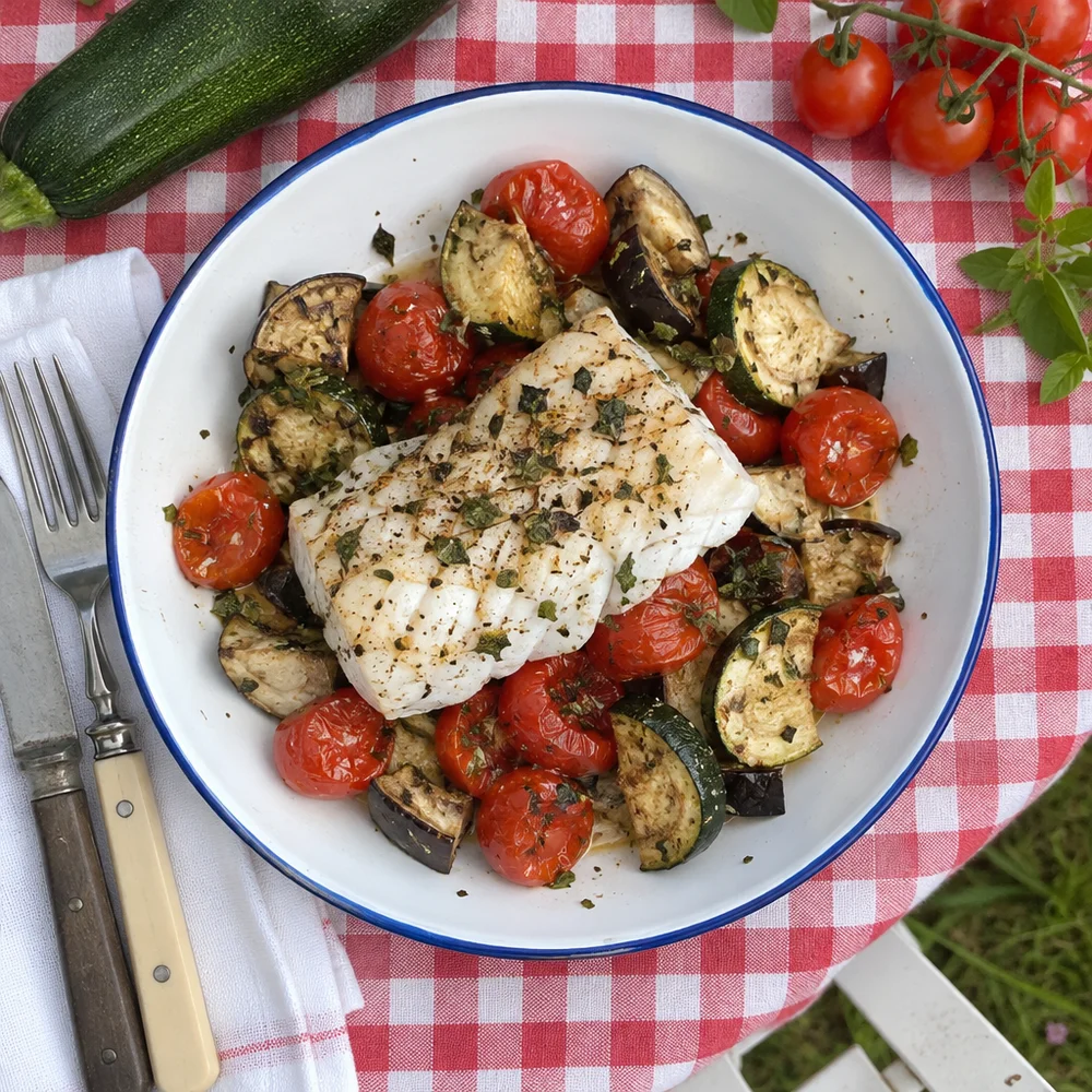 Mediterranean baked fish on roasted vegetables