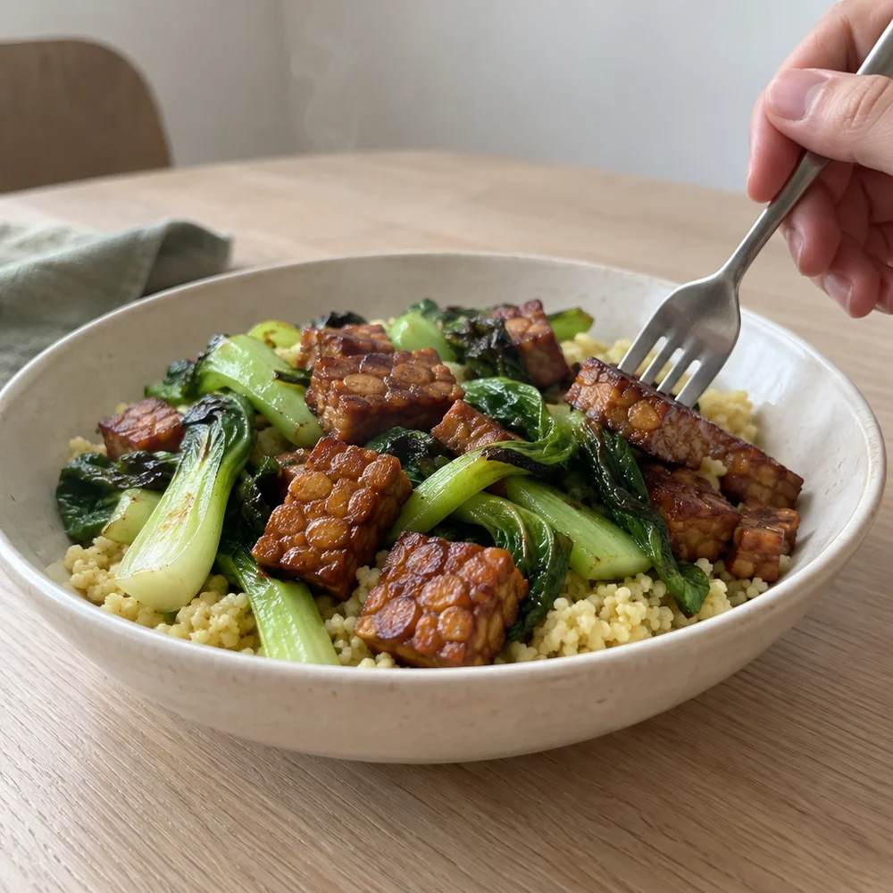 Vegan tamarind tempeh on millet with pak choi
